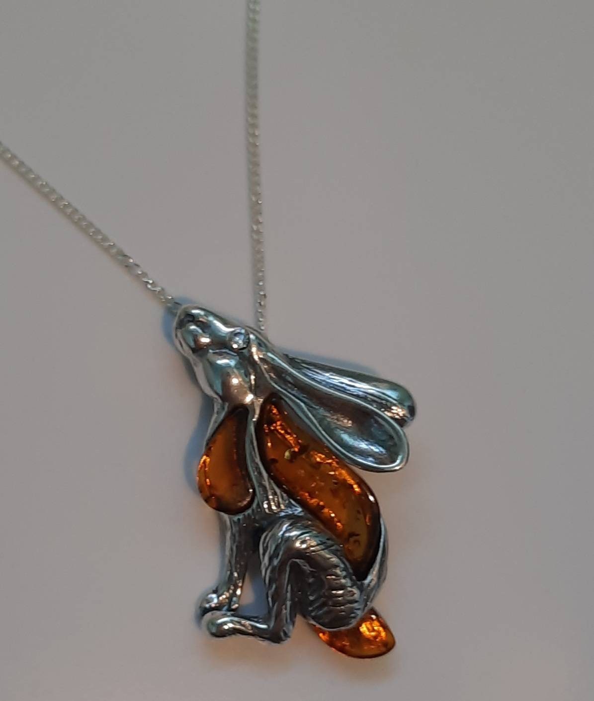 Beautifu designer sterling silver and cognac amber star gazing hare necklace